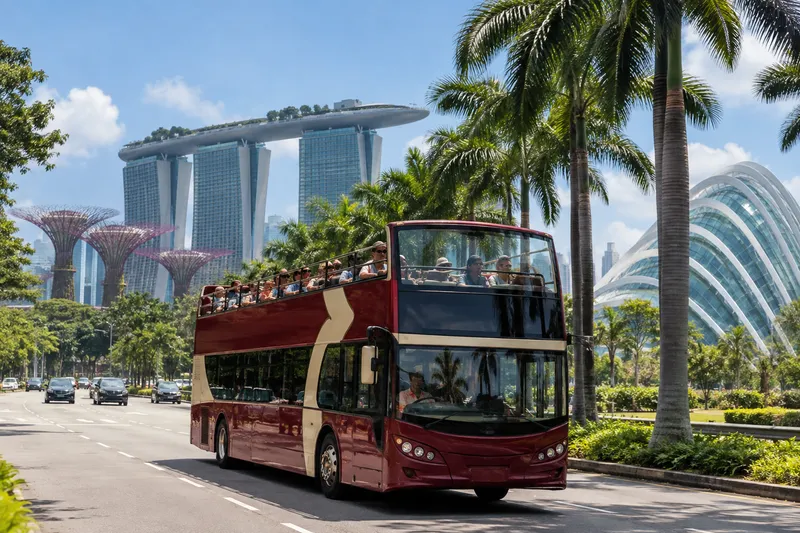 Open-top double-decker sightseeing bus in Singapore with Marina Bay Sands behind
