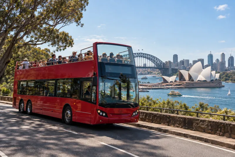 Open-top Big Bus Sydney double-decker overlooking harbour with Opera House and Bridge