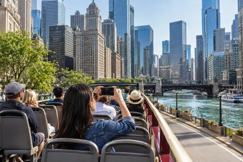 Open-top sightseeing bus touring downtown Chicago along the Chicago River