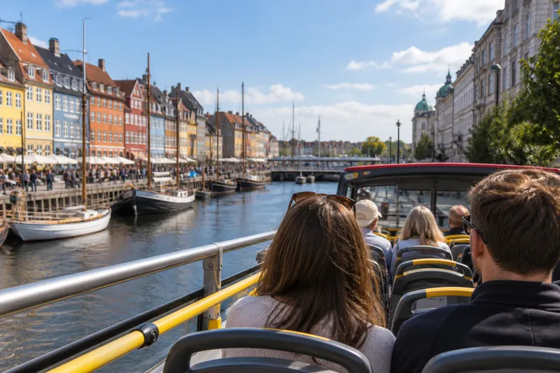 Open-top sightseeing bus passing Nyhavn in Copenhagen