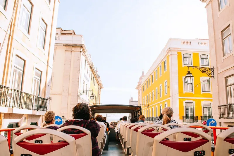 Open-top sightseeing bus touring Lisbon’s colorful historic streets