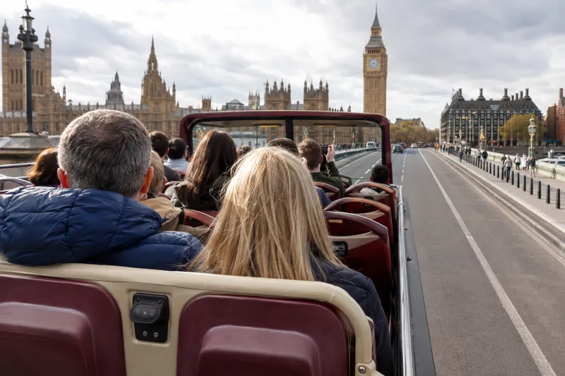Open-top sightseeing bus crossing Westminster Bridge in central London