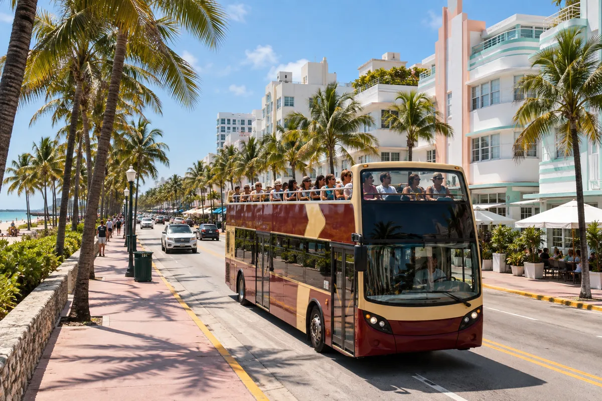 Open-top double-decker sightseeing bus on a palm-lined coastal avenue in Miami