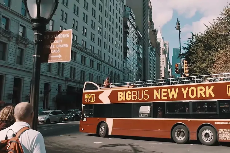 Open-top double-decker hop-on hop-off bus on a New York city street