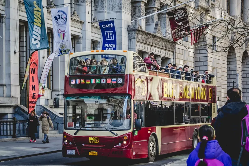 Open-top double-decker sightseeing bus in New York City traffic
