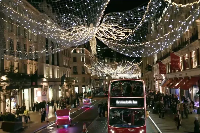 Tootbus London Discovery open-top bus on central London street at night