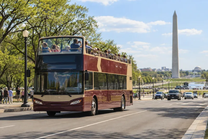 Open-top sightseeing bus on the National Mall in Washington DC with the Washington Monument