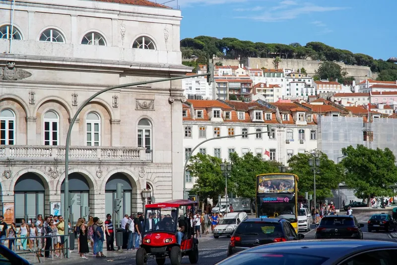 Open-top Yellow Bus double-decker sightseeing bus driving through Lisbon